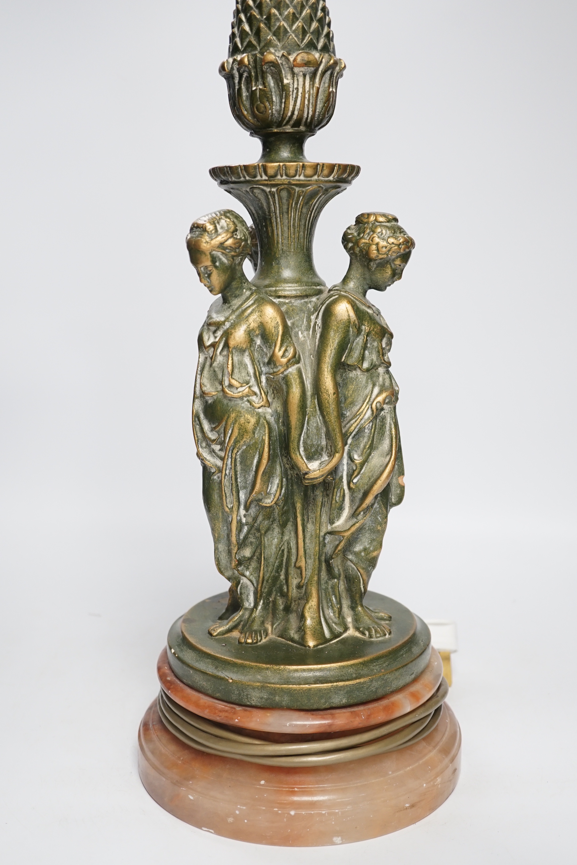 A Three Graces painted resin table lamp, partially gilded, raised on circular rouge marble base, 51cm high overall